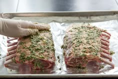 two raw meats are being prepared on tin foil