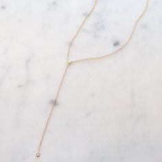 14k gold lariat features 2 bezel set diamonds with a total carat weight of 0.10. It can be worn at 16", 17" or 18" and has an additional 3" drop. Great for a night out or pairs well with a t-shirt. -14k gold We make every effort to keep this style in stock but sometimes it does sell out! If that happens, please allow up to 8 weeks for us to make this just for you. If you need something by a specific date please do not hesitate to reach out & confirm a ship date with us before ordering: shop@kati Gold Diamond Long Drop Necklace, Minimalist Gold Diamond Drop Necklace, Gold Long Drop Diamond Necklace, Fine Jewelry, Minimalist Gold Diamond Lariat Necklace, Gold Diamond Lariat Drop Necklace, 14k Yellow Gold Lariat Diamond Necklace, Yellow Gold 14k Diamond Lariat Necklace, Yellow Gold 14k Lariat Diamond Necklace, Gold Long Drop Diamond Necklace As A Gift