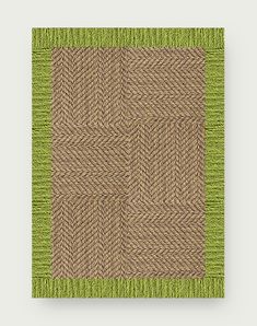 a green and brown area rug on top of a white wall