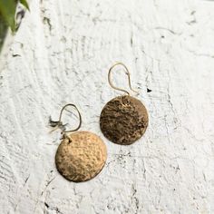 Dangling brass "coin" earrings. Simple, but trendy and stylish, sparkling brass coins hammered and polished by hand. Earrings on the photo are 1". Hammered Brass Earrings For Festivals, Hammered Brass Earrings For Festival, Bohemian Gold Hammered Earrings, Hammered Brass Festival Earrings, Minimalist Hammered Bronze Earrings, Everyday Copper Hammered Earrings, Gold Hammered Bohemian Earrings, Everyday Hammered Copper Earrings, Bronze Hammered Dangle Earrings