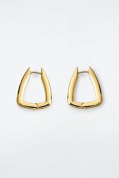 These sculptural hoop earrings drop from the lobe in a softly squared shape. They're made from post-consumer recycled brass that's plated in gold and have a hinged closure for secure wear. Hinge closureBrass is a versatile material that can be recycled numerous times without losing any of its properties Shell: 100% Post-consumer recycled brass. Plating: 100% Gold. Excluding trims Earring length is 0.78" All Weather Boots, Weather Boots, Earrings Drop, Women Accessories Jewelry, Soft Suede, Hat Hairstyles, Leather Working, Handbag Accessories, Sunglasses Accessories