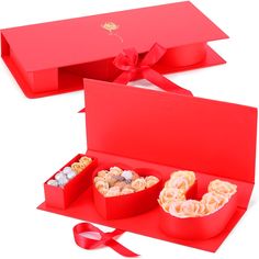 two red boxes filled with different types of treats