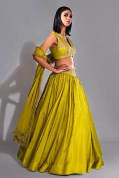 Green padded blouse with floral pattern golden zari, dori, upcycled sequins embroidery. Comes with coordinating embroidered waistbelt and crystal hangings. Paired with frill hem dupatta. - Aza Fashions Festive Cotton Silk Lehenga With Gota Work, Cotton Silk Sets With Gota Work For Reception, Bollywood Cotton Silk Choli For Reception, Cotton Silk Choli With Cutdana For Reception, Cotton Silk Cutdana Choli For Reception, Reception Cotton Silk Choli With Cutdana, Resham Embroidered Cotton Silk Choli For Reception, Designer Cotton Silk Choli With Gota Work, Cotton Silk Lehenga With Zari Work For Reception