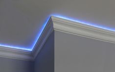 the corner of a room with blue lights on it