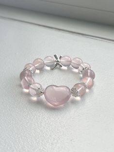 ❤️Add a touch of elegance and tranquility to your jewelry collection with this beautiful Rose Quartz bracelet. Crafted from smooth, round beads, this bracelet captures the gentle pink hue of Rose Quartz, known as the stone of universal love. ▫️Material: Genuine Rose Quartz Round Beads; Heart-shaped Rose Quartz, DIY accessories  ▫️Bead Size: 12mm ▫️Rose quartz heart size: 15mm*10mm ▫️Bracelet length: fits wrist length 15cm (6in)+  ✅Care Instructions: ✔️Keep away from harsh chemicals and prolonged exposure to water. ✔️Clean with a soft cloth to maintain its natural shine. 🔺Please note:  ☑️All photos are taken in the natural daylight with no filter applied. ☑️Each bead in the bracelet is unique. The presence of dark spots, white lines and yellow hues add to the natural beauty of your bracele Elegant Heart Beads Bracelet, Healing Beaded Bracelets With Round Beads For Valentine's Day, Elegant Heart Beads Stretch Bracelet Gift, Elegant Rose Quartz Stretch Bracelet With Round Beads, Elegant Heart Beads Stretch Bracelet For Gift, Elegant Round Beads Stretch Bracelet For Valentine's Day, Elegant Heart Bracelet With Round Beads For Valentine's Day, Elegant Beaded Bracelets For Valentine's Day, Elegant Heart Beaded Bracelet