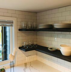 a kitchen counter with plates and bowls on it