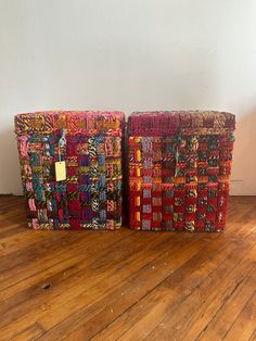 two woven baskets sitting on top of a wooden floor