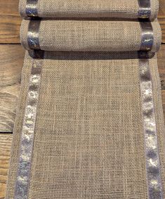 an upholstered area rug on wooden flooring with metal trimmings and buttons