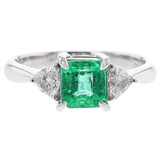 A 1.09 Carat Square-Cut Emerald Three Stone Ring made in Platinum. Diamond Weight: 0.32 carats. Ring Size 6.25. Gross Weight: 4.71 grams. Luxury Trillion Cut Emerald Ring For Formal Occasions, Gia Certified Trillion Cut Diamond Ring For Formal Events, Gia Certified Trillion Cut Diamond Ring For Formal Occasions, Luxury Gia Certified Trillion Cut Emerald Ring, Gia Certified Trillion Cut Formal Rings, Luxury Gia-certified Trillion Cut Emerald Ring, Formal Gia Certified Trillion Cut Ring, Luxury Trillion Cut Diamond Emerald Ring, Luxury Trillion Cut Emerald Diamond Ring