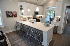 a kitchen with an island and bar stools