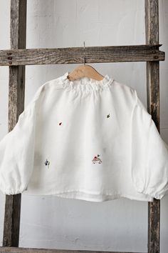 Exclusive meadow parachute tunic shirt with long puff sleeves and ruffled neckline is made of 100% soft medium weight linen.  Details: - Choose size in the drop down menu - Colour: White - Composition: 100% Oeko-Tex certified linen - Embroidered hedgehog, ladybug, blueberry, leaf, wild strawberry, clover & bee (front and back) - Ruffled sleeves - Ruffled neckline  - Medium weight linen - Linen care: machine wash gentle; tumble dry low, ironing optional - The price is for one tunic, other picture Cotton Puff Sleeve Tops With Smocked Cuffs, Cotton Tops With Smocked Cuffs And Puff Sleeves, White Balloon Sleeve Top With Smocked Cuffs, White Balloon Sleeve Tops With Smocked Cuffs, Cotton Tops With Balloon Sleeves And Smocked Cuffs, White Blouse With Balloon Sleeves And Smocked Cuffs, Spring Smocked Long Sleeve Tops, Spring Smock Long Sleeve Tops, Spring Smock Top With Long Sleeves