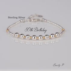 Sterling Silver Milestone Birthday Bracelet  🎁 Perfect 80th Birthday Gift 🎁  💖🎉One Bead Representing Each Decade 🎂👏 5mm Sterling Silver Beads 3mm Sterling Silver Textured Beads 2mm Sterling Silver Round Beads; 2mm Gold Plated Sterling Silver Beads 3mm Gold Plated Sterling Silver Textured Beads S925 Sterling Silver Premium Quality Clasp, Extension Chain & Heart Tag Threaded With 49 Strand Beading Wire For Strength & Flexibility Handmade in England with Love, Quality and Care. This bracelet Silver Beaded Bracelets For Anniversary, Classic Adjustable Beaded Bracelets For Anniversary, Elegant Beaded Bracelets For Birthday And Mother's Day, Anniversary Bracelet With Silver Round Beads, Anniversary Silver Beads Round Bracelets, Silver Dainty Beaded Bracelets For Anniversary, Dainty Silver Beaded Bracelets For Anniversary, Dainty Round Beaded Bracelets For Anniversary, Dainty Beaded Bracelets For Anniversary