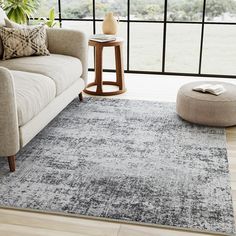 a living room with a couch, chair and rug