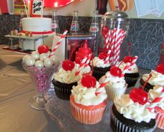 cupcakes and candy on a table at a party