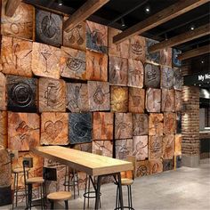 a wooden table and chairs in front of a wall made out of wood planks