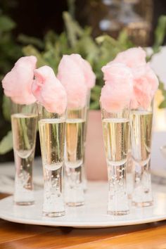 four champagne glasses filled with pink flowers on top of a white tablecloth and text that reads instagram