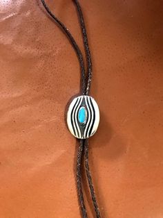 This Sterling Silver and Turquoise Bolo Tie was designed and hand crafted by me. It measures 2 1/4 by 1 3/4 inches. It works well on a 1 1/4 or 1 inch belt. Belt is not included. Turquoise is from the Kigman Arizona mine and hand cut by me. This is very heavy and would last for ever. The first three pictures show with oxidation and you can choose how you like it. Comes with sterling silver tips which are not shown. Other custom tip can be made for an additional charge. Bolo Tie Men, Turquoise Bolo Tie, Silver Tips, Silver Casting, Bolo Ties, Stone Inlay, Bolo Tie, Tie Accessories, American Jewelry