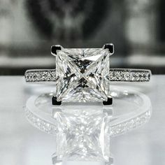 a princess cut diamond ring with pave set shoulders