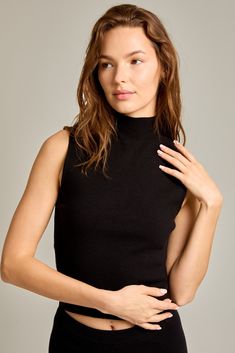 High neck Sleeveless Sweater top Chic High Neck Tank Top For Night Out, Casual Sleeveless Mock Neck Top For Fall, Black High Neck Knit Top For Spring, Elegant Fitted Sleeveless Mock Neck Top, Black Fitted Sleeveless Mock Neck Top, Chic Sleeveless Mock Neck Top For Work, Black Stretch Sleeveless Mock Neck Top, Black Turtleneck Tank Top For Spring, Fitted Sleeveless Black Mock Neck Top