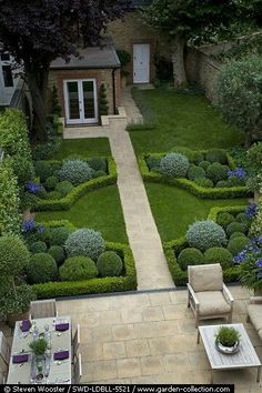 an outdoor garden is shown in the middle of a yard with lawn furniture and landscaping