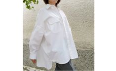 Material 97% Cotton  3% Elastane A white shirt in a wide version has become a classic part of a woman's wardrobe. Feel stylish and comfortable in this type of shirt. CARE INSTRUCTIONS - Dry clean - Hand wash White Office Tops With Pockets, White Office Top With Pockets, Oversized Plain Shirt For Work, Oversized White Shirt With Pockets, Oversized Plain Blouse For Workwear, White Relaxed Fit Blouse With Pockets, Oversized White Blouse With Pockets, Chic White Shirt With Pockets, Oversized White Blouse For Workwear