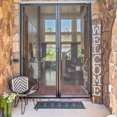 the front entrance to a home with glass doors