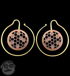 the earrings are made out of brass and has a beehive design on it