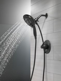 a shower head with water running from it's spout and handshowing