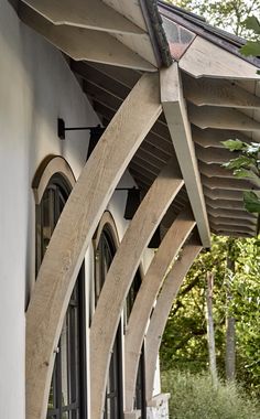 an arched wooden door on the side of a building