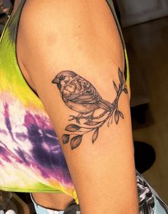 a woman with a bird tattoo on her arm