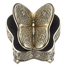 a gold and black butterfly sculpture on a white background