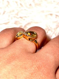 a person's hand with a gold ring on it