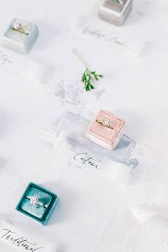 wedding rings and ring boxes on display for guests