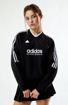 Stay cozy and stylish in the Tiro Fleece Sweatshirt from adidas. Featuring a flattering V-neckline and long sleeves with dropped shoulders, this sweatshirt offers a relaxed fit for all-day comfort. The iconic 3-Stripes down the sleeves and adidas logo graphic add a sporty touch, while the adidas rubber brand label ensures authenticity.Solid color sweatshirtV-necklineLong sleevesDropped shouldersadidas graphic and rubber brand labelRibbed trimming70% cotton, 30% recycled polyesterMachine washableModel is wearing a size smallModel measurements: 5’6.5” height, 32” bust, 23.5” waist, 35” hipLearn more about PacSun eco items adidas Womens Tiro Fleece Sweatshirt - Black size Small Black Clothes For Women, Adidas Womens, Adidas Sweatshirt, Brand Label, Adidas Sportswear, Fleece Sweatshirt, Stay Cozy, Logo Graphic, Adidas Logo