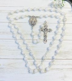 This beautiful rosary would be a wonderful gift for Baptism. Its features are: - 6mm White Porcelain Jade beads for Hail Mary beads - Rose Miraculous Medal centerpiece - Filigree crucifix The rosary is hand-made in Canada, and it is my blessing and honor to make it for you. For personalization: 💛  Please mention which #number of the centre and/or crucifix in "Personalization box". Otherwise, I'll make your rosary as in the picture. ❤️  Name/initial can be added on the rosary. Please let me know Personalized White Rosary For Mother's Day, White Spiritual Rosary With Miraculous Medal, Spiritual White Rosary With Miraculous Medal, Personalized White Rosary For Confirmation, White Rosary With 8mm Beads As Gift, White Spiritual Rosary For Mother's Day, Spiritual White Rosary For Mother's Day, Mother's Day White Spiritual Rosary, White Spiritual Rosary For Baptism