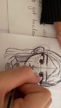 someone is drawing on paper with a pencil