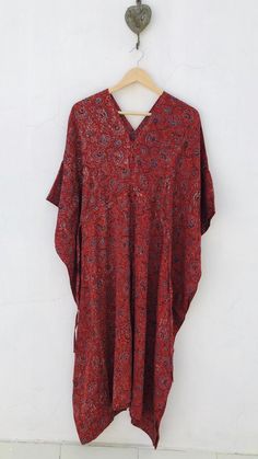 Block print Ajarakh silk blend kaftan - luxury loungewear - organic dyed Long Kaftan in a woven silk and cotton blend with a slight sheen. V neck with a tie knot around waist for gently draped effect. Size : One size fits all Chest (56 inch) Length (44 inch) Fabric : Modal silk - hand washable, soft against skin, wrinkle resistant & breathable fabric. Can be worn as a swim suit cover up ora dress! Ajarakh is a block printed textile that is resist dyed using natural dyes( minerals, scrap iron Red Bohemian Kaftan With Ikat Print, Patterned Kaftan With Kimono Sleeves For Festival, Bohemian Kaftan With Ikat Print And Kimono Sleeves, Festival Patterned Kaftan With Kimono Sleeves, Bohemian Batik Print Patterned Kaftan, Long Bohemian Patterned Kaftan, Red Oversized Bohemian Kaftan, Traditional Patterned Tunic Kaftan, Bohemian Block Print Kaftan For Loungewear