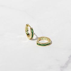 Beautifully crafted baguette style emerald huggies. Looks so elegant! Features baguette stones on both front and back sides. - - - D E T A I L S - - - * Made of 925 Sterling Silver * Inner Diameter: 9 mm * Outer Diameter: 11 mm * Available in 14k Gold or Rhodium plated over 925 Sterling Silver * We use a thick plating for a piece that will be with you for years to come * SOLD AS A PAIR * Thickness: 2.5mm * Nickel-Free and Hypoallergenic Made with 100% Pure Love ♡ Happy to answer any questions yo Luxury Small Hoop Green Earrings, Layering Diamond Necklaces, Earrings Emerald, Small Hoop Earrings, Emerald Earrings, Huggie Earrings, Emerald Jewelry, Delicate Earrings, Stunning Earrings