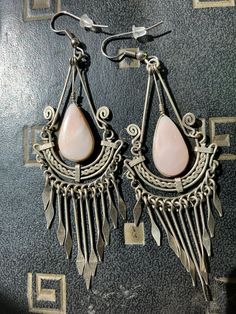 Vintage Boho dangled earrings! Colorful and dangling about 3 inches. Center stone is two sided and intact securely and no cracks or chips. Beautiful silver work. I do not know the metal, but you could change the ear wires if you have allergies to metal. Bohemian Drop Pierced Earrings, Metal Teardrop Danglers, Pierced Metal Teardrop Chandelier Earrings, Artisan Metal Chandelier Earrings With Dangle Shape, Metal Teardrop Dangle Earrings For Festivals, Festival Metal Teardrop Dangle Earrings, Bohemian Long Drop Pierced Earrings, Bohemian Drop Metal Earrings, Artisan Chandelier Dangle Earrings For Pierced Ears