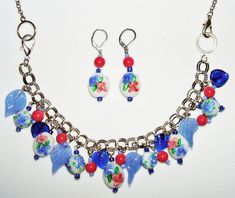 Get ready to add some statement jewelry to your collection with this stunning blue flower-themed jewelry set. The set includes a charming bracelet, a unique necklace, and a beautiful pair of earrings - all featuring intricate and colorful lampwork art glass designs. The set is perfect for adding a pop of color and personality to any outfit, and the blue, pink, and green flower motifs are ideal for nature lovers and those who appreciate artisanal craftsmanship. Whether you're heading to a party or just want to add some sparkle to your daily wear, this jewelry set is sure to turn heads and start conversations. This fabulous artisan designed and created set features gorgeous LAMPWORK Art Glass BLUE and PINK FLOWER glass bead accents! There are wonderful blue glass leaf and deep pink glass bea Pink Flowers Art, Charming Bracelet, Flower Motifs, Glass Designs, Unique Necklace, Flowers Art, Themed Jewelry, Green Flower, Deep Pink