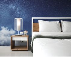 a bedroom with a night sky wall mural