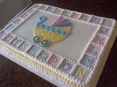 a cake that is decorated with letters and a baby's stroller on it