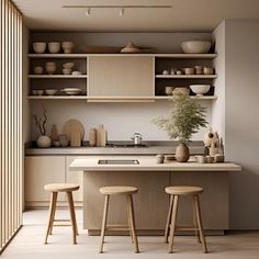 a kitchen with two stools in front of the counter and shelves on the wall