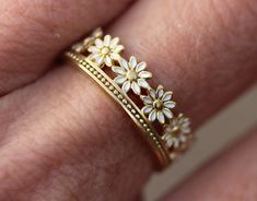 When I was a kid, I loved picking daisies and making little wreaths or rings out of them. Unfortunately, these only lasted for a very short time... This daisy ring will last a lot longer:) :) It is made from thick 18k gold plated 925 sterling silver (vermeil quality) and the daisy petals are white enameled. The ring is adjustable in size (all sizes between 6-9), so you can wear it on different fingers and it makes a fantastic gift. Also great for your bridesmaids.  Registered Design. Our exclusi Daisy Petals, Billie Eillish, Daisy Ring, Best Gifts For Her, Enamel Ring, Men's Jewelry Rings, Girls Jewelry, Flower Ring, Pretty Jewellery