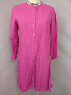 "Soft surface and rich color on this vintage linen tunic shirt jacket. The label is Eileen Fisher, fabric content 100% linen. Photographed un ironed. Natural slightly nubby linen surface, mid weight, color is a wonderful dark magenta pink - not quite as bright/ florescent looking as it photographed. Shape is slim tunic style with a skinny band collar and button front all the way down, deep side slits & long sleeve. Size is marked XS, shown on a 6mannequin, please go by measurements. Machine Spring Button-up Tunic With Buttons, Button-up Tunic For Daywear, Long Sleeve Linen Dress With Buttons For Work, Relaxed Fit Button-up Tunic, Long Sleeve Linen Dress With Button Closure, Single Breasted Long Sleeve Linen Top, Long Sleeve Tunic With Buttons For Daywear, Spring Linen Tunic With Buttons, Casual Linen Long Sleeve Dress With Button Closure