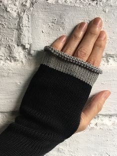 These black cotton handwarmers are a sister product to my popular alpaca fingerless gloves. They are fully vegan as they're all cotton and are great for cycling, chilly morning dog walks and for those with allergies to animal fibre. I also have many customers with arthritis or Reynaud's syndrome who wear these daily to alleviate their symptoms, as they are tight enough at the wrist to offer relief. Long enough to fit under your cuffs, these wrist warmers are great for men or women. The fingertip edge is trimmed in grey cotton and you can fold it back for times when you need more access. There's a slit for the thumb.  Can be hand washed as cotton and should be dried flat. You can iron them as cotton.  I make all my pieces myself in my little north Devon studio and all designs are my own. Black One-size Warm Leg Warmers, Black Warm One-size Leg Warmers, Black One Size Leg Warmers, Black Warm Leg Warmers One Size, Cozy Black Knitted Leg Warmers, Black Leg Warmers For Cold Weather, One Size, Cozy Black Leg Warmers For Cold Weather, Black Fingerless Gloves, Gloves Knitted