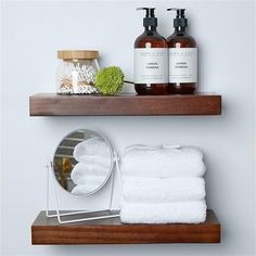 two shelves with towels and soaps on them