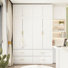 a living room with white cabinets and a plant in the corner on the table next to it