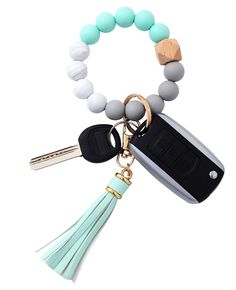 a keychain with a tassel on it and a cell phone charm attached to it