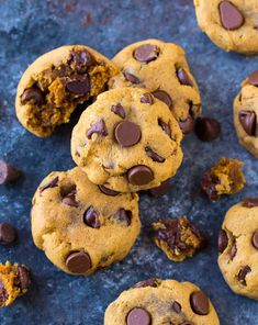 several chocolate chip cookies on a blue surface